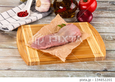 Raw pork tongue over board 134852201