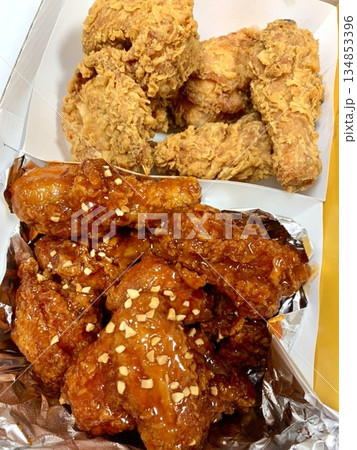 Crispy Korean fried chicken, perfectly glazed with a sweet and spicy sauce. Ideal for food photography and menus, showcasing the irresistible crunch and flavor of this beloved dish. Crispy Korean fried chicken, perfectly glazed with a sweet and spicy sauce. Ideal for food photography and menus, showcasing the irresistible crunch and flavor of this beloved dish. 134853396