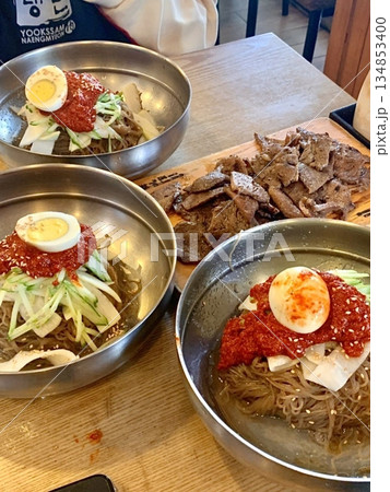 Authentic Pyongyang naengmyeon with chewy buckwheat noodles in cold, clear broth, offering a refreshing and delicate flavor. Perfect for traditional Korean cuisine menus and summer dishes. 134853400