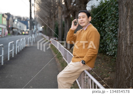 スマホで通話する中高年男性 スマホで通話する中高年男性 134854578