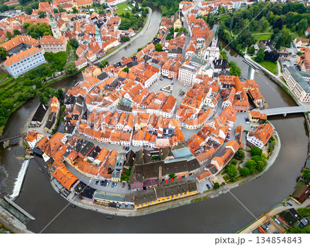 This breathtaking view captures Cesky Krumlov from above, highlighting the charming architecture and winding Vltava River. The town's historic buildings are bathed in the soft light of morning. 134854843