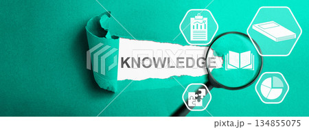 The word "knowledge" is revealed through torn paper, a magnifying glass focusing on a book icon, and surrounding icons related to data, puzzles, and books, symbolizing learning and discovery The word "knowledge" is revealed through torn paper, a magnifying glass focusing on a book icon, and surrounding icons related to data, puzzles, and books, symbolizing learning and discovery 134855075