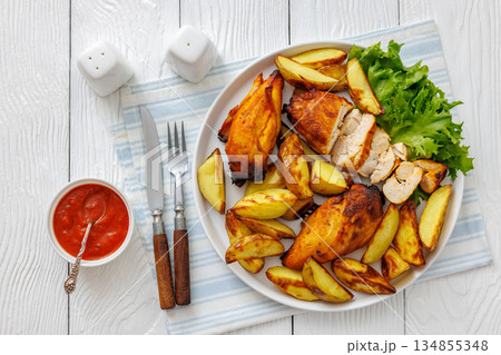 grilled juicy chicken breasts and roasted potatoes grilled juicy chicken breasts and roasted potatoes 134855348