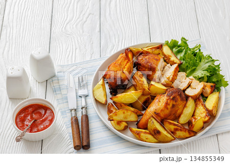 grilled juicy chicken breasts and roasted potatoes 134855349