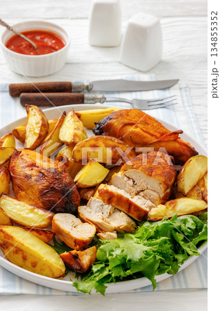 grilled juicy chicken breasts and roasted potatoes 134855352