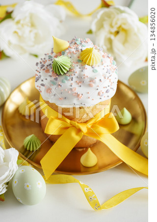 Close up Easter Cake with Flowers and Pastel Eggs on White Background Close up Easter Cake with Flowers and Pastel Eggs on White Background 134856020