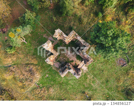 Aerial view of the Chapel of the Exaltation of the Holy Cross in Bristev. The stone ruins stand amidst lush greenery, showcasing historical architecture and natural beauty during daylight. Aerial view of the Chapel of the Exaltation of the Holy Cross in Bristev. The stone ruins stand amidst lush greenery, showcasing historical architecture and natural beauty during daylight. 134856127
