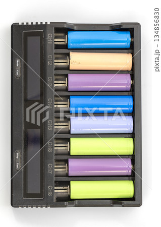 Overhead view of an eight-channel battery charger with batteries of various colors inserted. Overhead view of an eight-channel battery charger with batteries of various colors inserted. 134856830