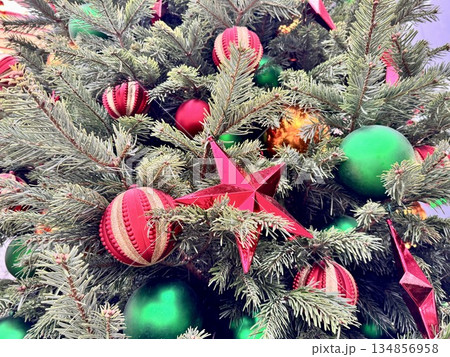 Bright Christmas Tree toys are hanging on the tree. New Year Bright Christmas Tree toys are hanging on the tree. New Year 134856958