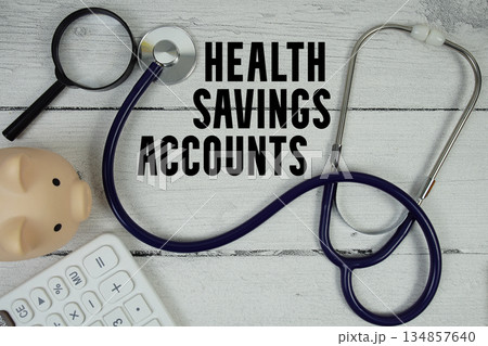 Health Savings Accounts (HSA) text with Stethoscope and magnifying glass on wooden background Health Savings Accounts (HSA) text with Stethoscope and magnifying glass on wooden background 134857640
