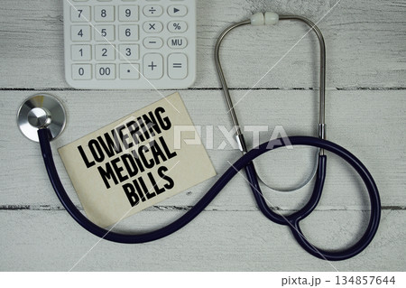 Lowering Medical Bills text with Stethoscope and calculator on wooden background Lowering Medical Bills text with Stethoscope and calculator on wooden background 134857644