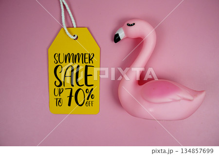 Price tag Sale 70% with pink flamingo summer decorations on pink background Price tag Sale 70% with pink flamingo summer decorations on pink background 134857699