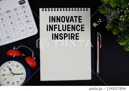 Innovate. Influence. Inspire text with calculator with alarm clock on black background 134857804