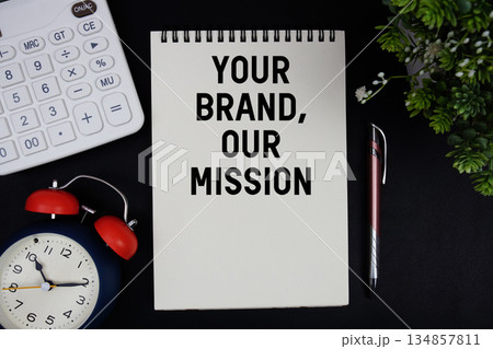 Your Brand, Our Mission text with calculator with alarm clock on black background 134857811