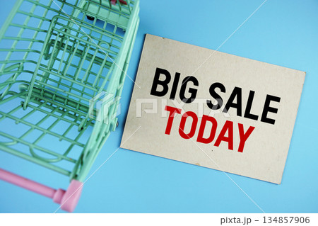 Big Sale Today text on paper card with trolley shopping cart on blue background 134857906