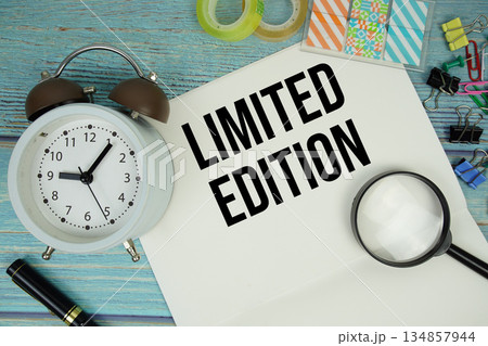 Limited Edition text written on notepad with alarm clock and magnifying glass flat lay on wooden background Limited Edition text written on notepad with alarm clock and magnifying glass flat lay on wooden background 134857944