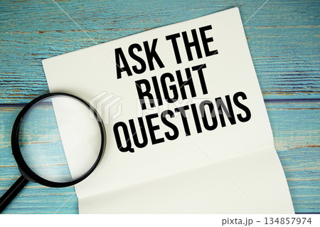 Ask The Right Questions text written on notepad with magnifying glass flat lay on wooden background Ask The Right Questions text written on notepad with magnifying glass flat lay on wooden background 134857974