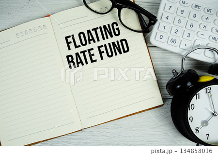 Floating Rate Fund text on notepad with alarm clock, magnifying glass and calculator on wooden background Floating Rate Fund text on notepad with alarm clock, magnifying glass and calculator on wooden background 134858016