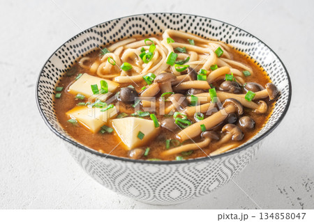Japanese udon soup with Shimeji mushrooms, tofu, and rich dark umami broth Japanese udon soup with Shimeji mushrooms, tofu, and rich dark umami broth 134858047