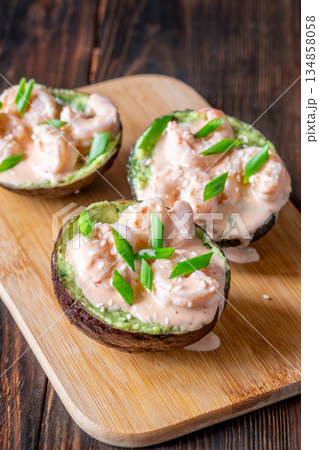 Avocado halves filled with guacamole and shrimp topped with spicy sriracha mayo Avocado halves filled with guacamole and shrimp topped with spicy sriracha mayo 134858058