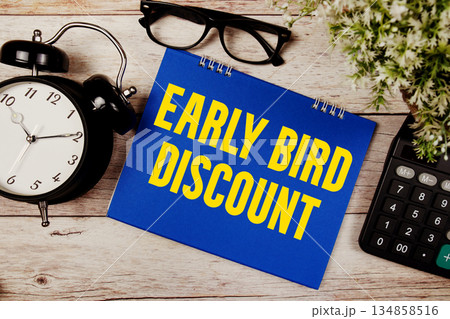 Early Bird Discount text with alarm clock and calculator on wooden background Early Bird Discount text with alarm clock and calculator on wooden background 134858516