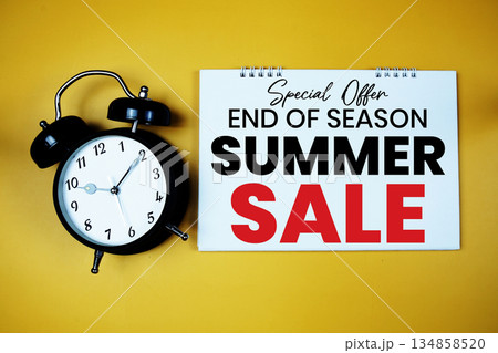 End Of Season Summer Sale text with alarm clock on yellow background 134858520