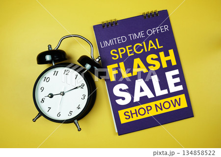 Flash Sale text with alarm clock on yellow background 134858522
