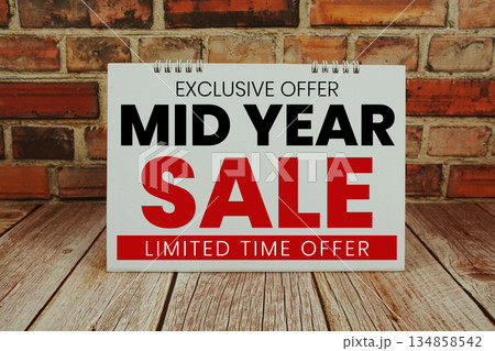 Mid Year Sale text Promotion and Marketing on wooden background 134858542