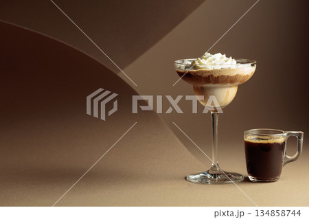 Black coffee and iced coffee cocktail on a beige background. 134858744