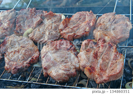 Process of cooking meat. Steak on barbecue. Preparation appetizing pork outside Process of cooking meat. Steak on barbecue. Preparation appetizing pork outside 134860351