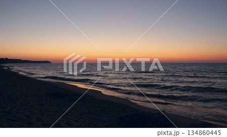Sunset on Baltic Sea. Waves on seashore in evening Sunset on Baltic Sea. Waves on seashore in evening 134860445