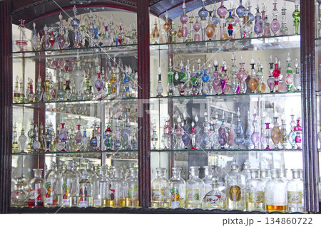 Figured glass retorts and colored bottles for aroma and perfume. Perfume shop Figured glass retorts and colored bottles for aroma and perfume. Perfume shop 134860722