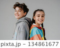 happy teenage boy and girl stand back to back gray background 134861677