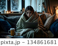 sick young woman feeling cold wrapped in a blanket 134861681