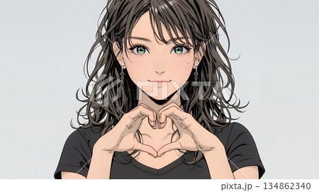 ハートマークを手で作り愛情表現をしている若い女性