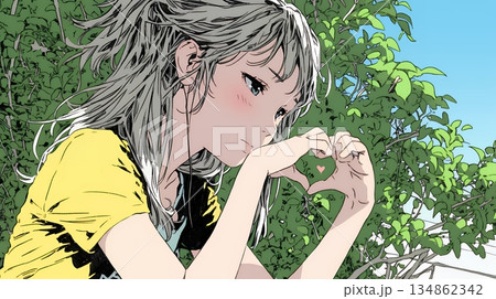 ハートマークを手で作り愛情表現をしている若い女性