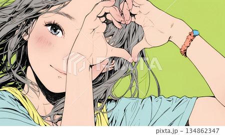 ハートマークを手で作り愛情表現をしている若い女性