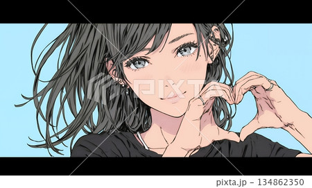 ハートマークを手で作り愛情表現をしている若い女性