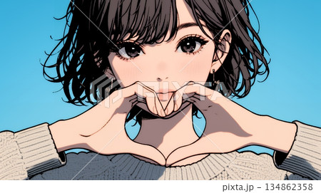 ハートマークを手で作り愛情表現をしている若い女性