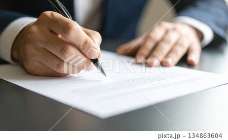 Person signing a digital smart contract document with a glowing signature beam illuminating the scene 134863604