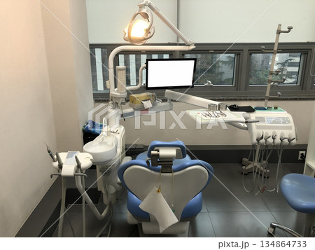 Modern Dental Clinic Interior with Dental Chair, Equipment, and Tools Ready for Patient Treatment in a Bright Medical Environment Modern Dental Clinic Interior with Dental Chair, Equipment, and Tools Ready for Patient Treatment in a Bright Medical Environment 134864733