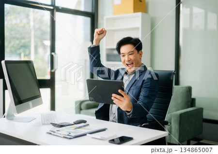 Asian businessman are delighted and happy with the work they do on their tablet, laptop and taking notes Asian businessman are delighted and happy with the work they do on their tablet, laptop and taking notes 134865007