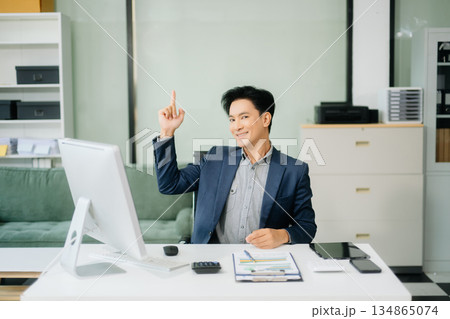 Young attractive Asian male office worker business suits smiling at camera 134865074