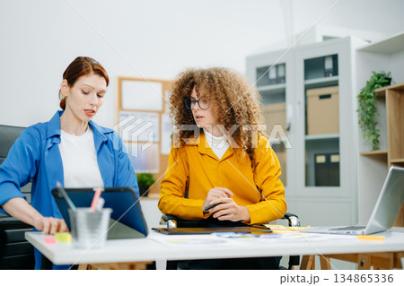 UX UI designers in modern office working on app wireframes, color palettes, and digital tools. Creative teamwork, planning, technology UX UI designers in modern office working on app wireframes, color palettes, and digital tools. Creative teamwork, planning, technology 134865336