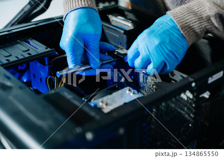 Electronics technician, electronic engineering electronic repair, electronics measuring and testing, repair and maintenance concepts.uses a voltage meter to check and upgrade Electronics technician, electronic engineering electronic repair, electronics measuring and testing, repair and maintenance concepts.uses a voltage meter to check and upgrade 134865550