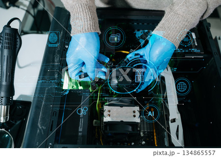 Closeup of technician in gloves holding CPU cooler and heat gun over desktop PC. Ideal image for computer repair, cooling system, and hardware Closeup of technician in gloves holding CPU cooler and heat gun over desktop PC. Ideal image for computer repair, cooling system, and hardware 134865557