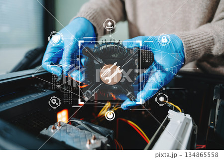 Closeup of technician in gloves holding CPU cooler and heat gun over desktop PC. Ideal image for computer repair, cooling system, and hardware Closeup of technician in gloves holding CPU cooler and heat gun over desktop PC. Ideal image for computer repair, cooling system, and hardware 134865558