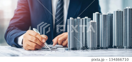 Real Estate Agent Reviewing 3D Model of Property in Modern Office Setting 134866710