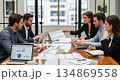 Business team analyzing data and reports in modern office setting 134869558