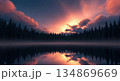 Serene forest lake at sunset with misty atmosphere and starry night sky 134869669